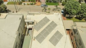 Aerial shot of solar panels on a rooftop in Karachi, highlighting sustainable energy solutions in urban settings.