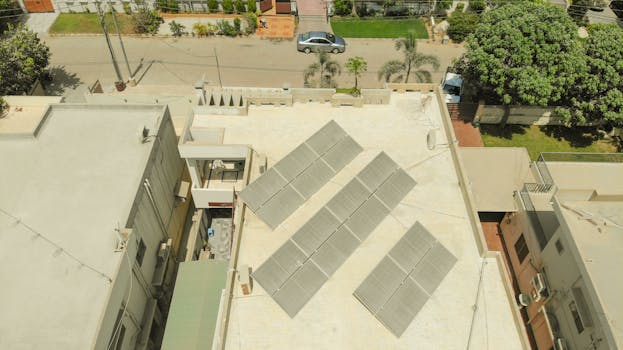 Aerial shot of solar panels on a rooftop in Karachi, highlighting sustainable energy solutions in urban settings.