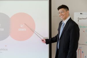 Smiling businessman presenting growth strategy in a modern meeting room.