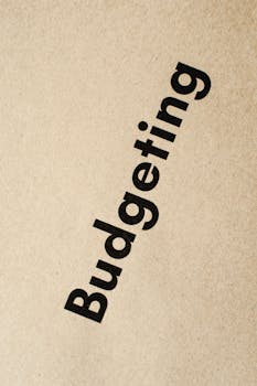 Detailed close-up of the word 'Budgeting' printed on brown textured paper.